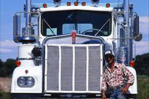 Trucker leaning against his truck